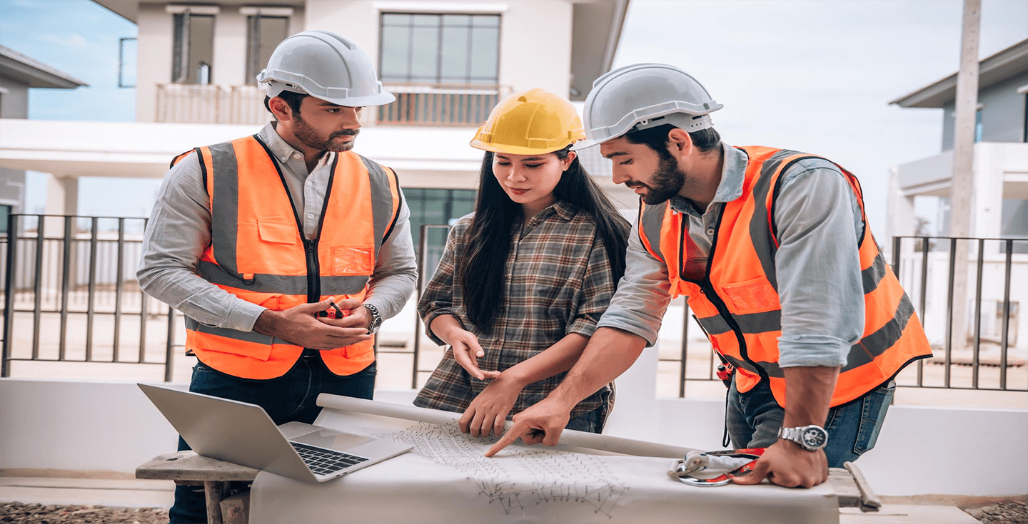 A site team reviewing construction plans together